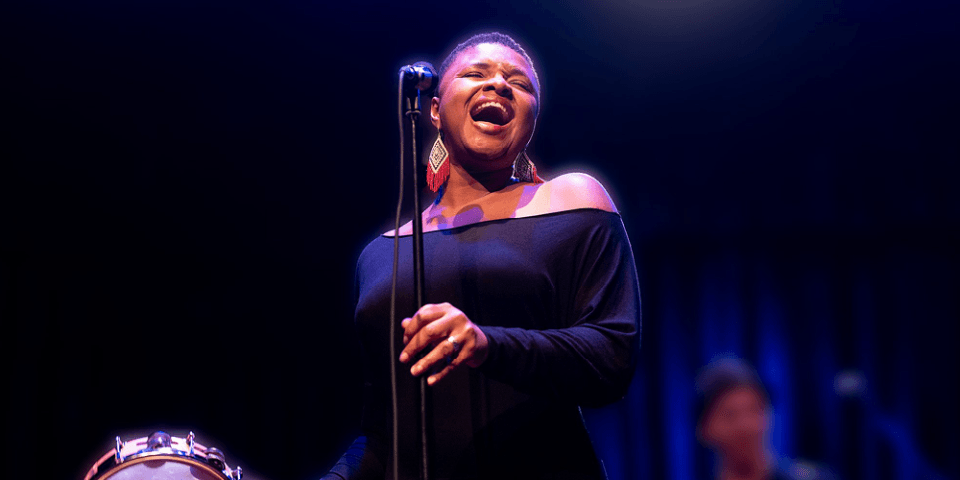 Jazz singer in a black dress at the Schomburg Center.