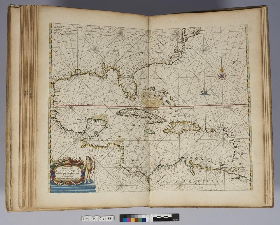 The atlas open to a two-page map of the Caribbean.