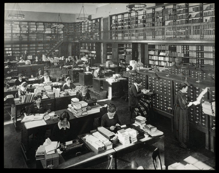 people reading and looking at card catalog
