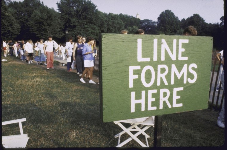 sign that reads "Line Forms Here"