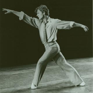 a man spreads his arms in a dance pose