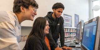 Teen Ambassadors using a computer at a library branch.