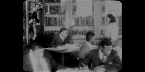Arturo Schomburg, the Schomburg Center's founder, and Catherine Latimer, NYPL's first Black librarian, with researchers amid the Schomburg Center's collections