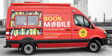 Red Bookmobile painted to resemble two rows of a book shelf. The side reads: The New York Public Library Bookmobile, A driving force for reading!